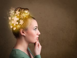 Young person thinking with glowing puzzle mind on grungy background