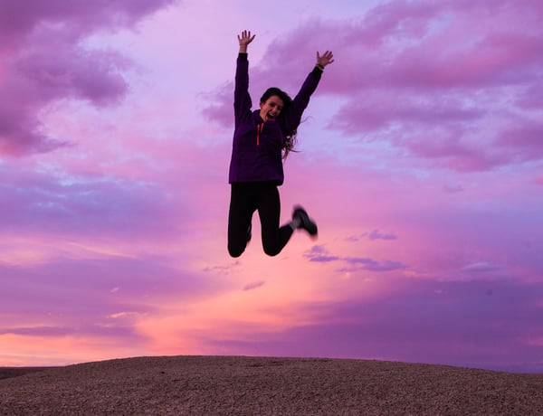 energy boost woman jumping up in the air