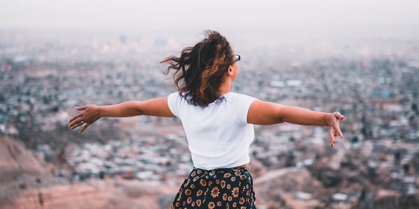 woman with arms spread out enjoying life